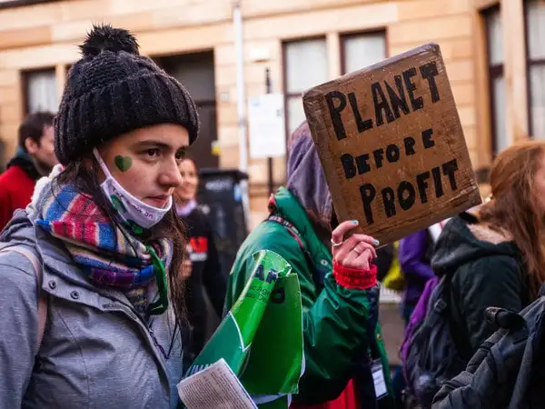 UK - Glasgow - COP26 Global Day of Action - Planet before profit placard