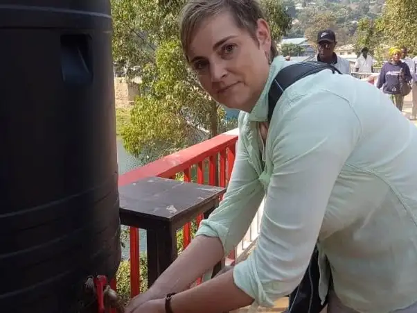 Africa - DR Congo - Christine washing her hands at one of the hand wash stations in Bukavu